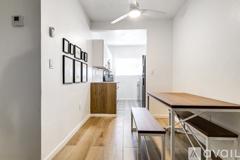 A long hallway with a bench and pictures on the wall.