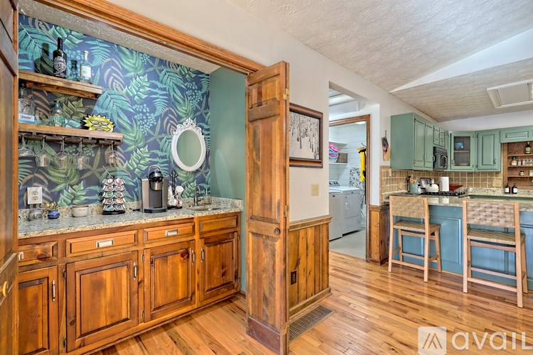 A kitchen with wooden cabinets and a green backsplash.