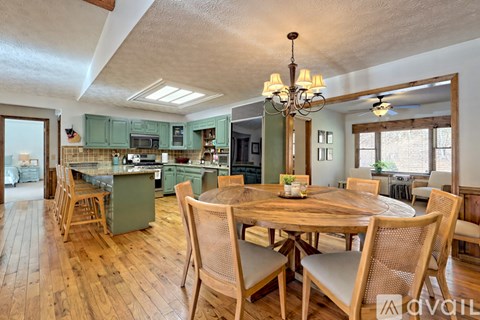 A dining room with a wooden table and chairs.
