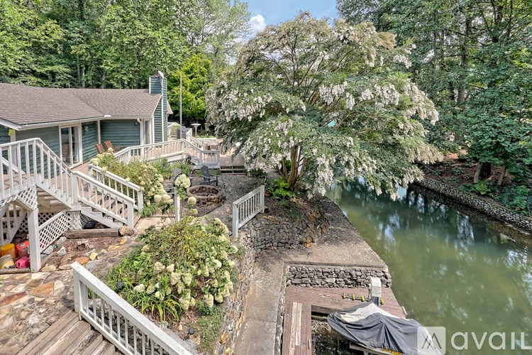 A house with a deck overlooking a river.