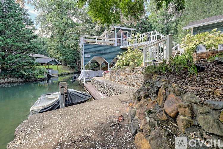 A house is built over a waterway with a bridge connecting the two sides.