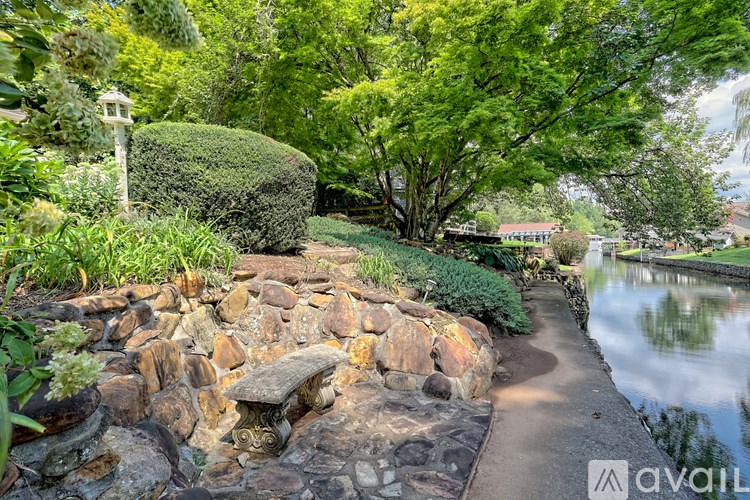 A garden with a pond and a stone path.