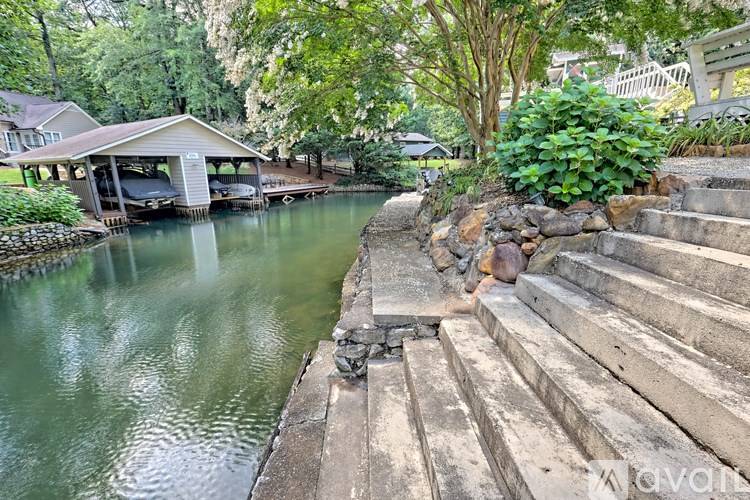 A serene outdoor scene with a wooden staircase leading down to a body of water.