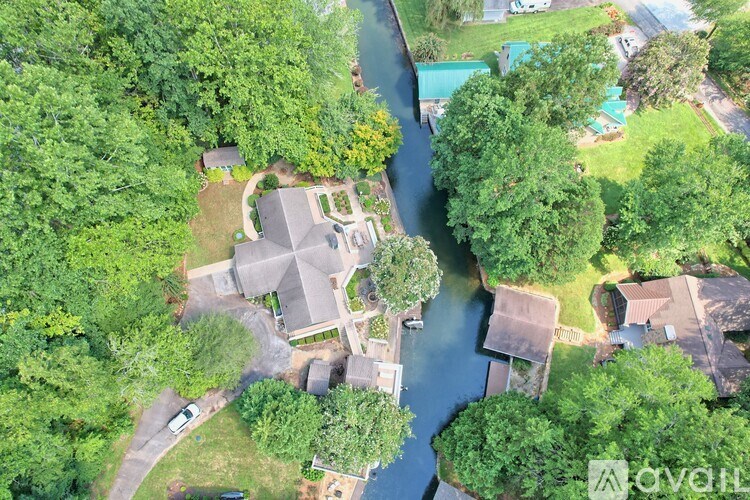 A bird's eye view of a residential area with a river running through it.