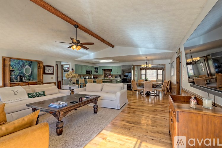 A living room with a white couch and a wooden coffee table.