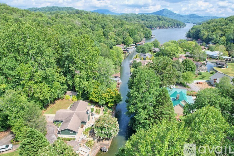 A bird's eye view of a residential area with a river running through it.