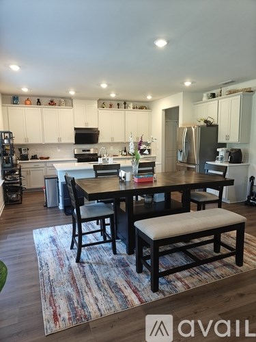 A kitchen with a table and chairs in the middle of the room.