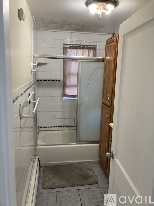 A bathroom with a shower and a toilet.