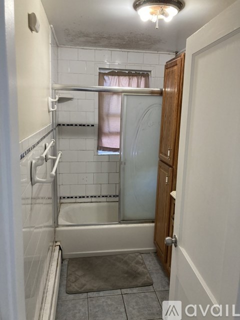 A bathroom with a shower and a toilet.