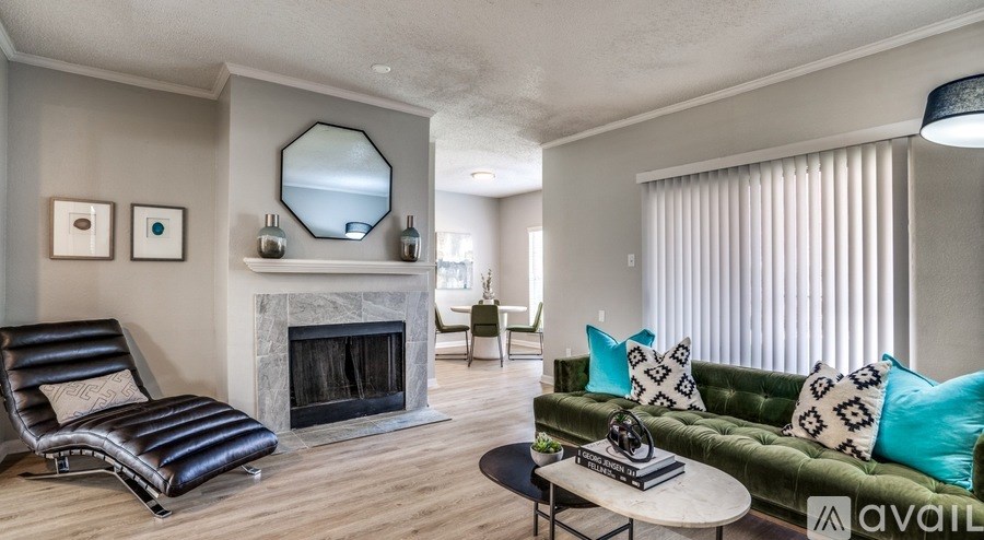 A living room with a fireplace, a sofa, and a chair.