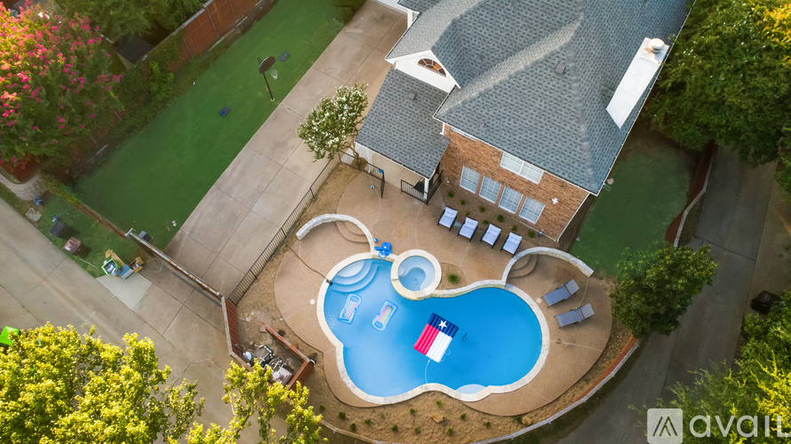 A backyard with a pool and a house.