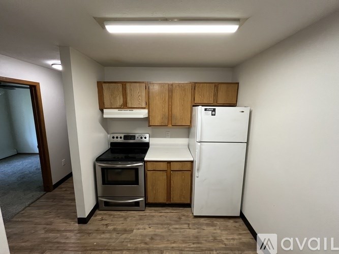 A kitchen with a white fridge, stove, and oven.