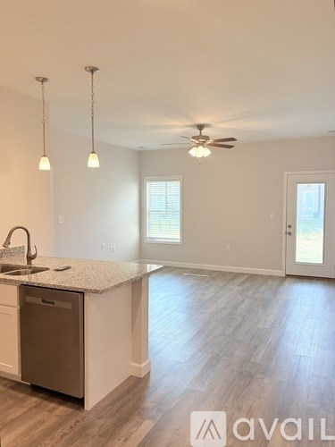A bathroom with a granite countertop and a white toilet.