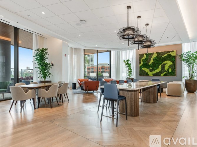 A modern dining room with a large table and chairs.