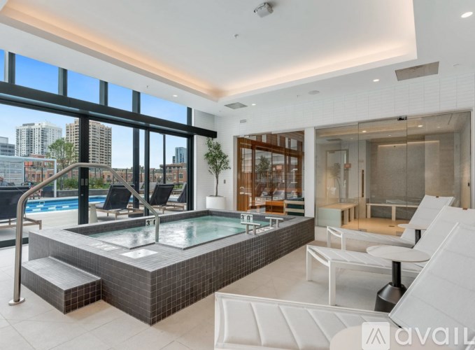 A modern indoor swimming pool with a view of the city.