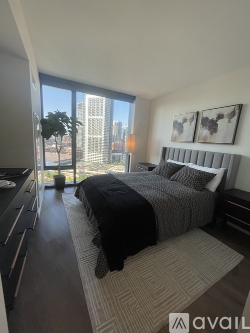 A bedroom with a large bed and a view of the city.
