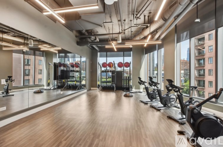 A gym with exercise bikes and a view of the city.