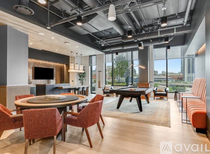 A modern dining room with a round table and chairs.