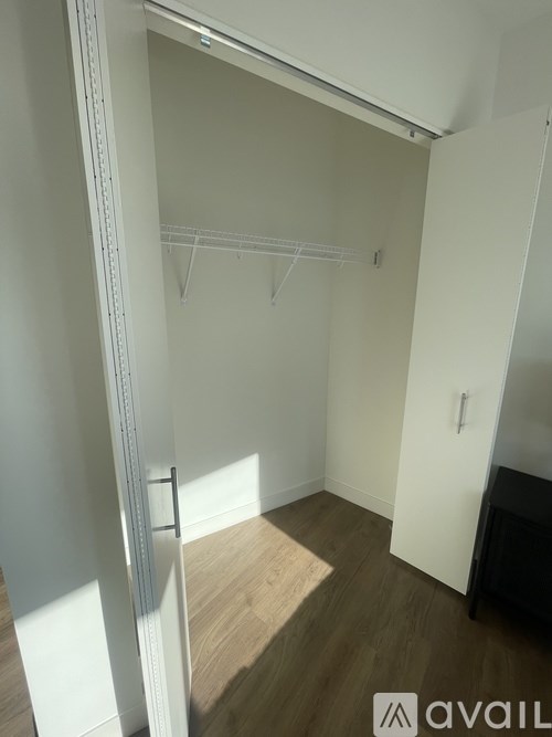 A room with a white wall and a wooden floor.