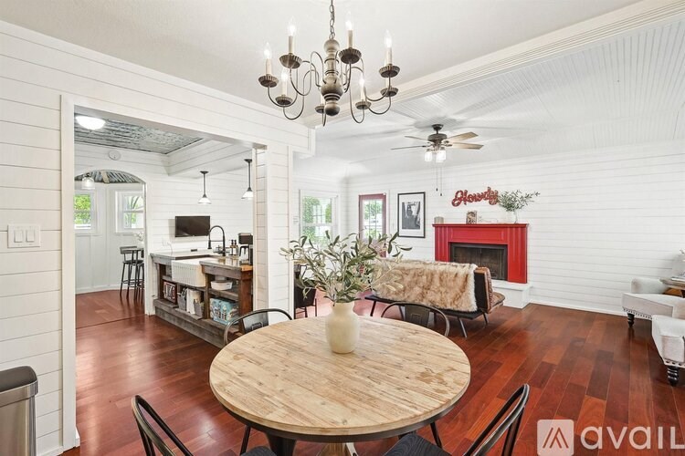 A living room with a wooden table and chairs.