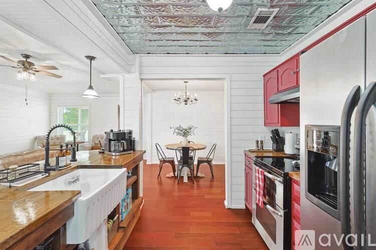 A kitchen with a wooden floor and white walls.