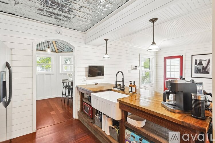 A kitchen with a wooden counter top and a sink.