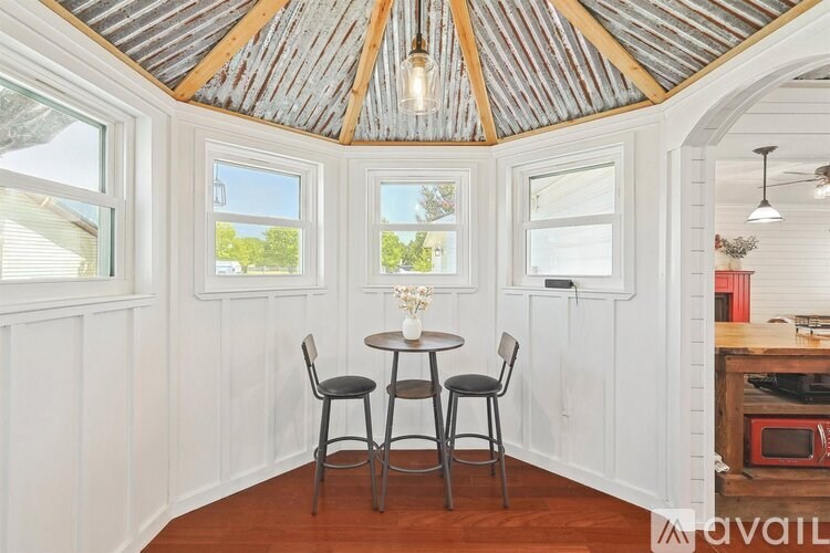 A dining area with a table and chairs.