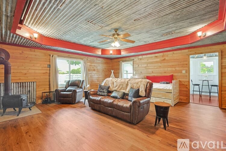 A living room with a wood floor and a wood ceiling.