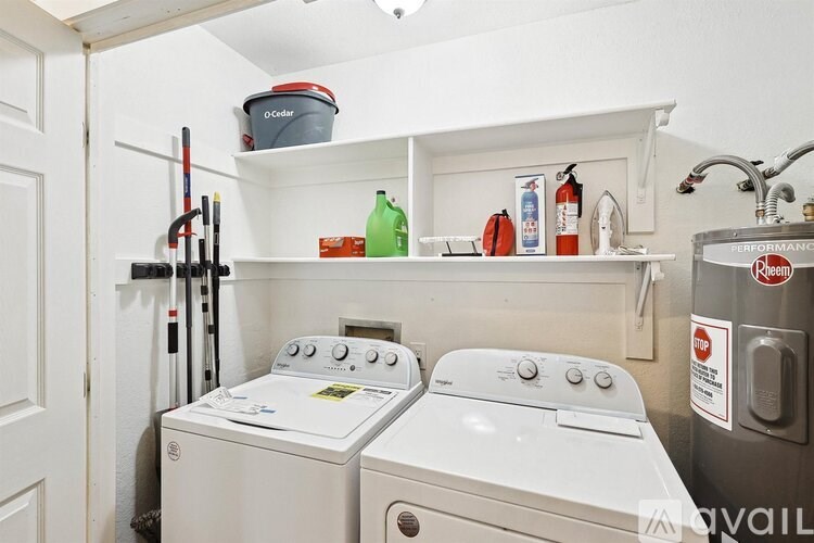 A white washer and dryer in a small laundry room.