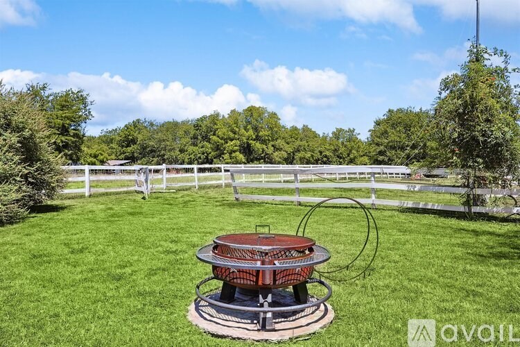 A hot tub sits in the middle of a grassy field.