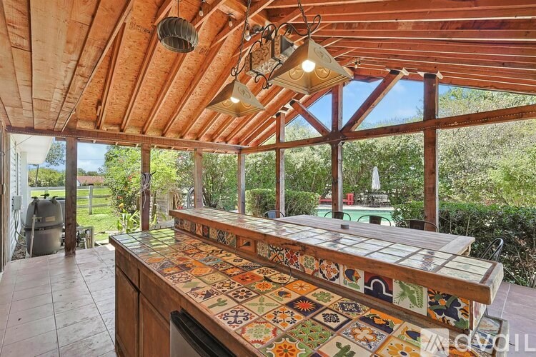 A kitchen with a tile backsplash and wooden cabinets.