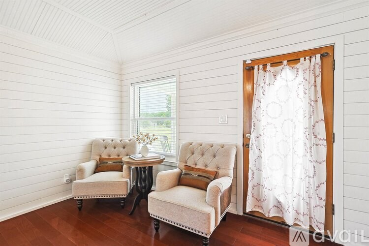 A living room with two chairs and a table.