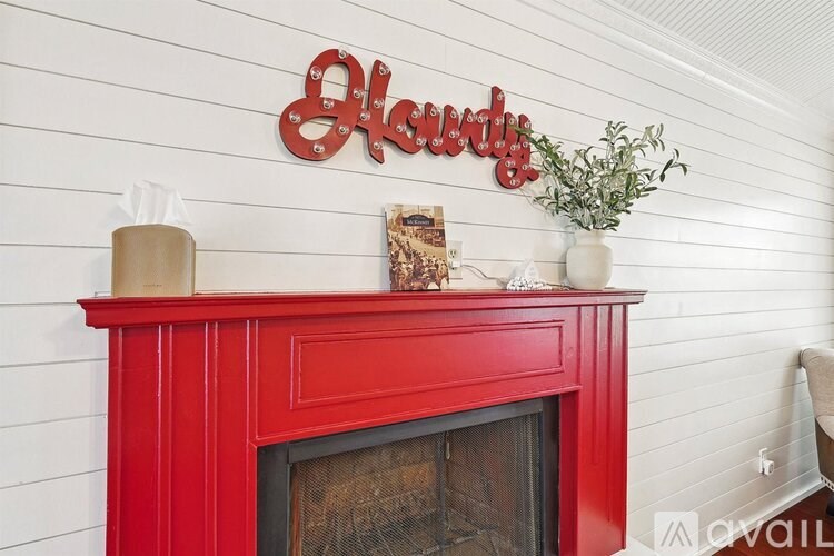 A red fireplace with a sign above it that says "Elegant".