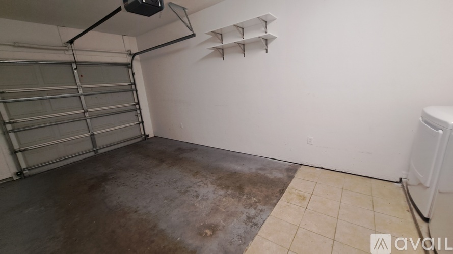 A garage with a white wall and a white door.