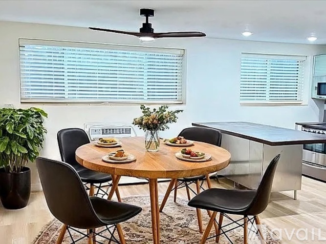 A dining room with a round table set for four.