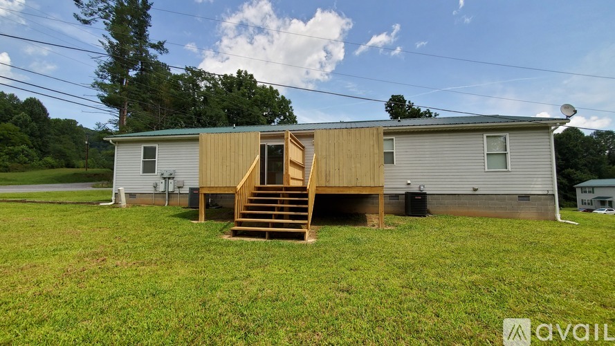 A house with a wooden deck is for sale.