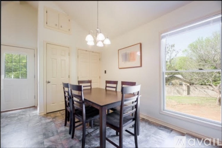 A dining room with a table and chairs.