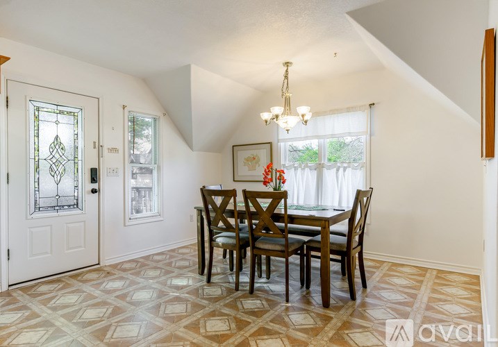 A dining room with a table set for four.
