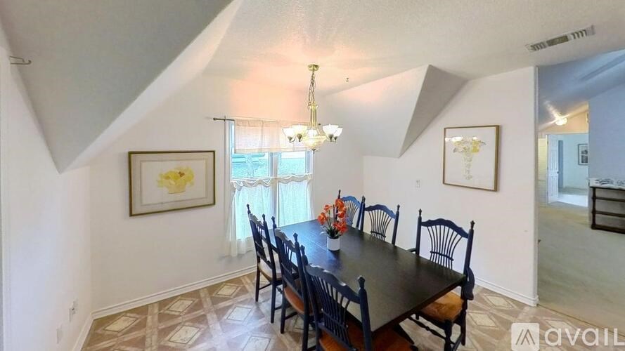 A dining room with a table set for four.