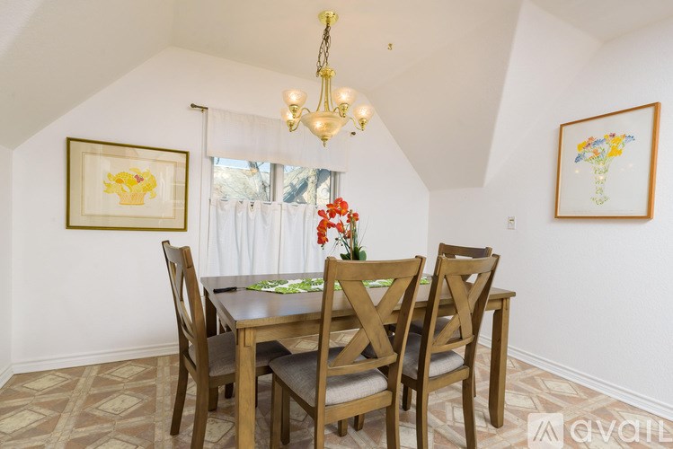A dining room with a table set for four.