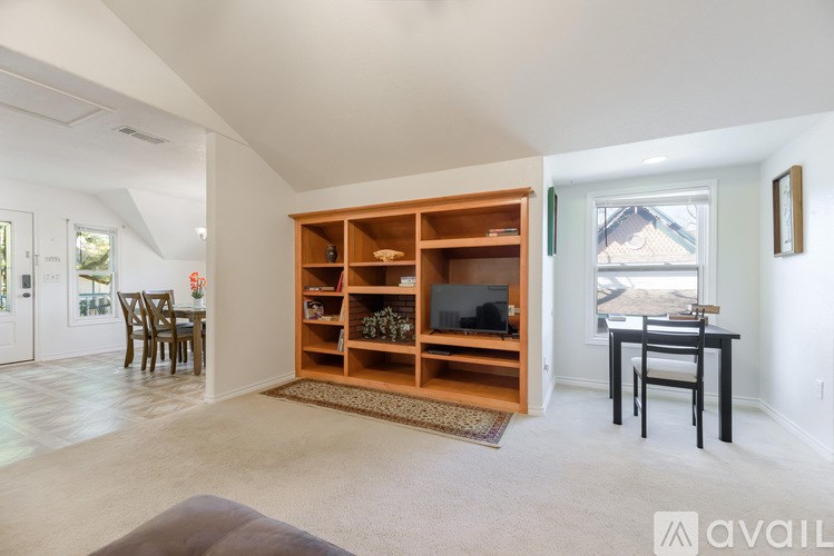 A living room with a television and a bookshelf.
