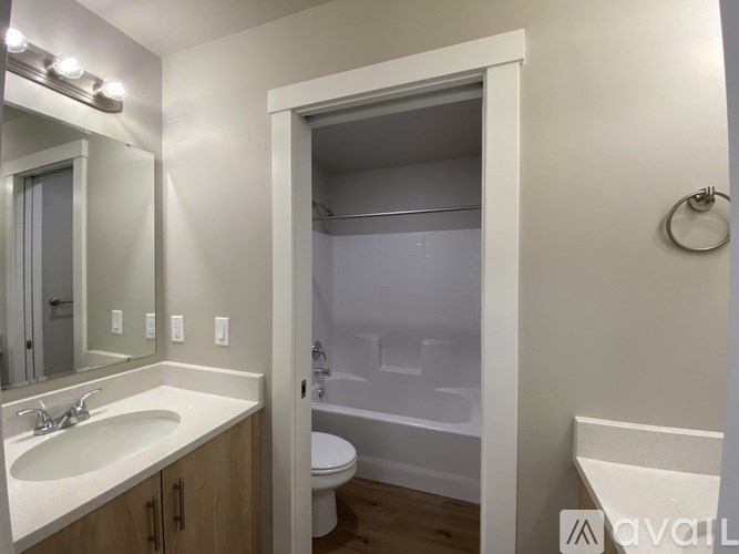 A bathroom with a sink, toilet, and bathtub.