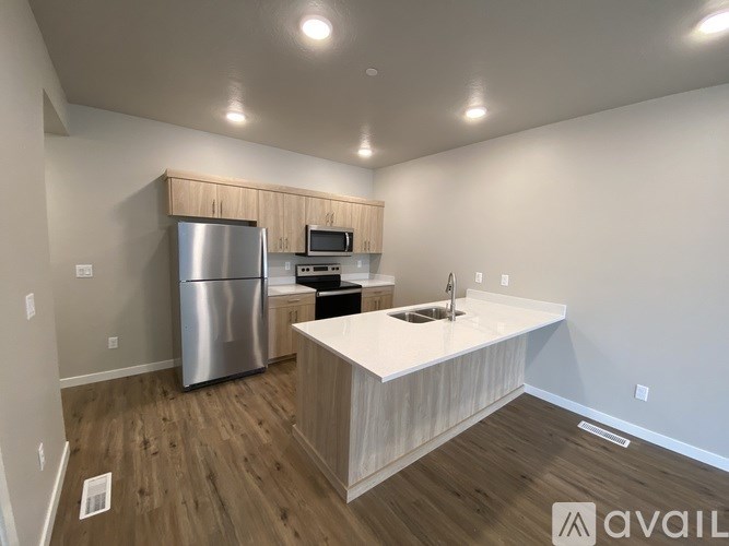 A kitchen with a stainless steel refrigerator and a white countertop.