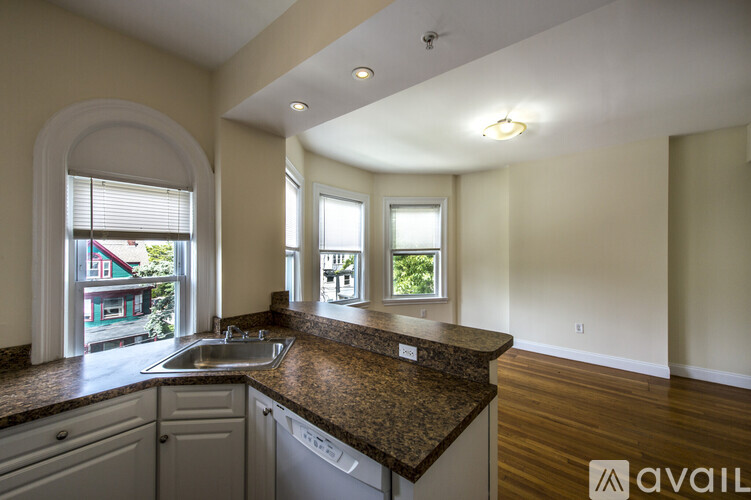 A kitchen with a granite countertop and a sink is available for rent.