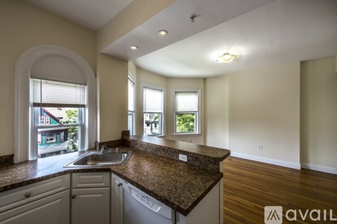 A kitchen with a granite countertop and a sink is available for rent.
