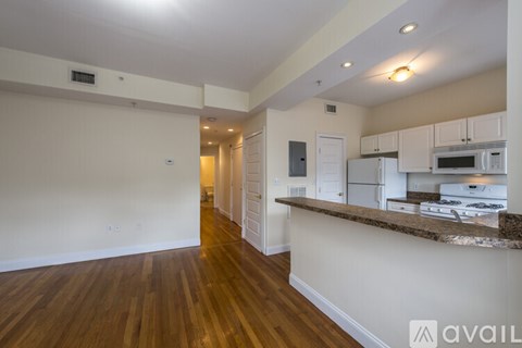 A kitchen area with white cabinets and a brown countertop.