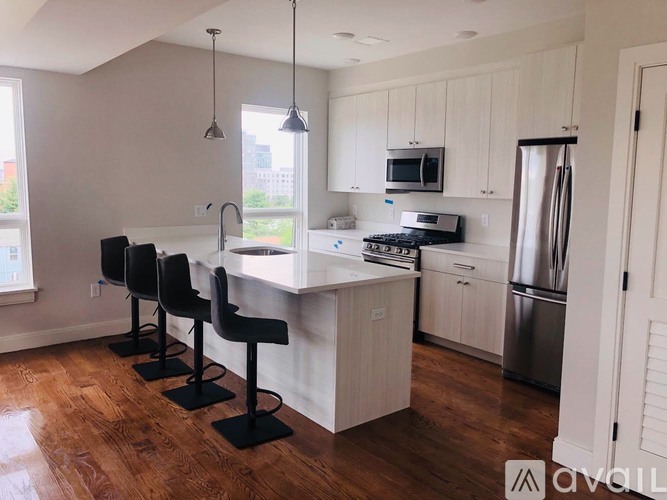 A kitchen with white cabinets and a wooden island.