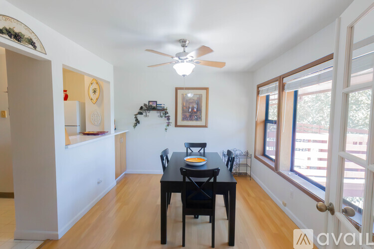 A dining room with a table and chairs.