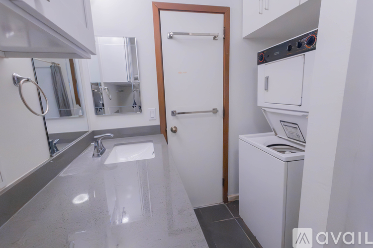 A kitchen with a white sink and a white oven.