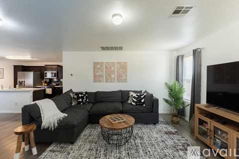 A living room with a grey couch and a coffee table.